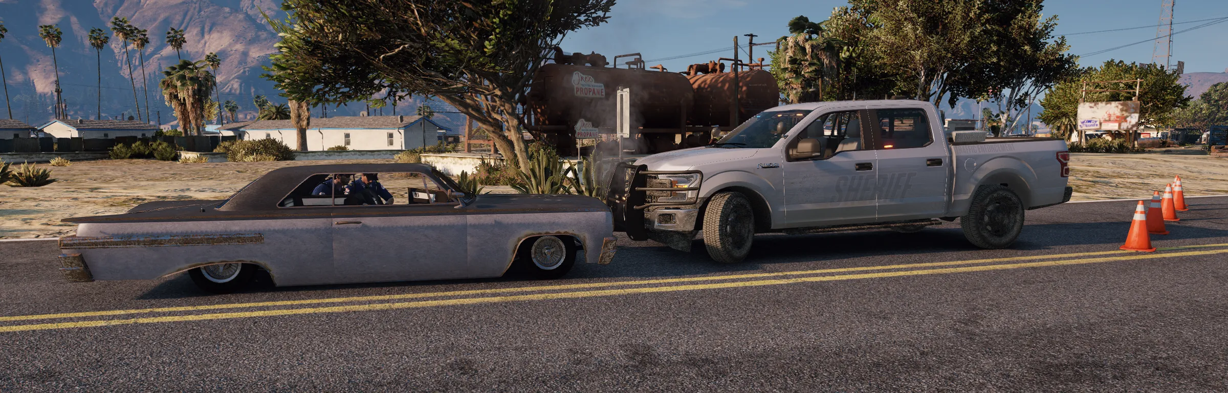 A daytime traffic stop on a residential street, a marked truck pulled in behind a lowered sedan.