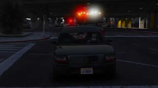A patrol vehicle approaching on a dark road, headlights on