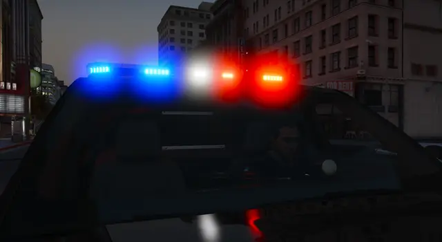 A close view of a lit light bar on a patrol car roof at night