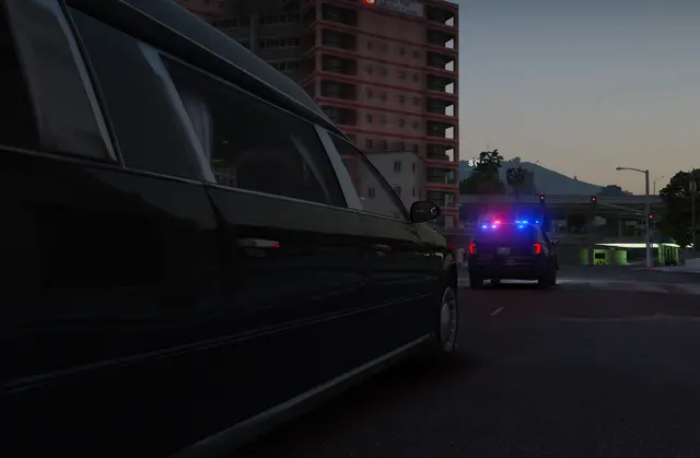 A limousine and patrol unit stopped together on a city street