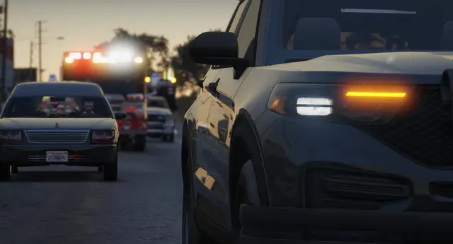 A patrol unit alongside traffic with its lights on