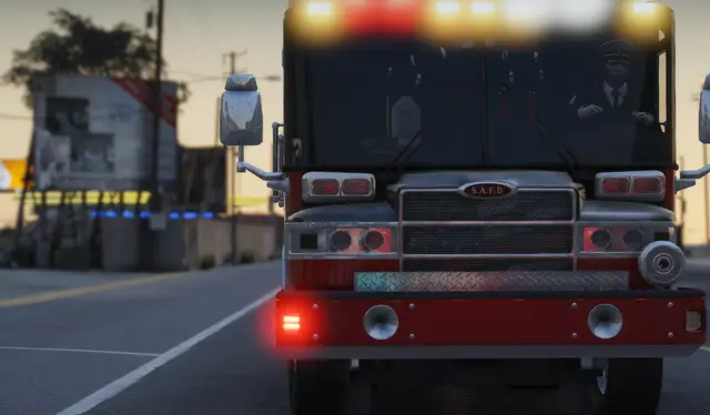 A fire engine front-on with its warning lights running