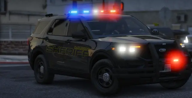A Sheriff's Office patrol SUV with its lights on at dusk