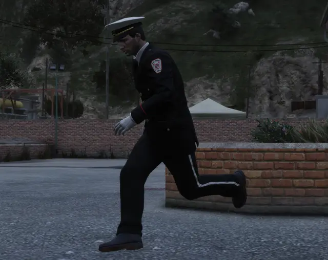 An officer running along a wall at night
