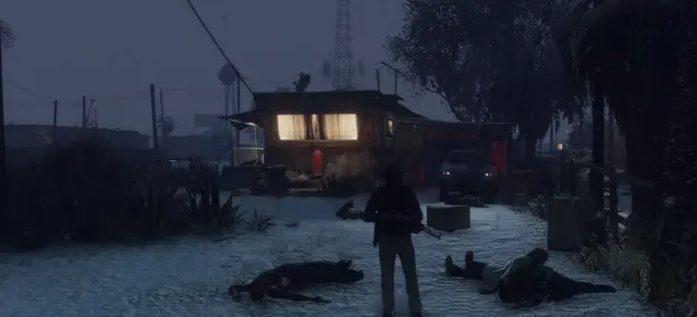 A body in the snow outside a lit house at night