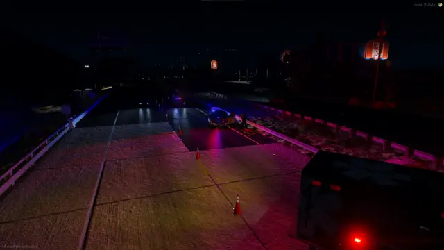 A bridge at night with vehicles crossing