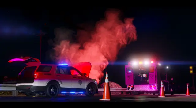 A wrecked car on its side at a scene marked with flares and cones