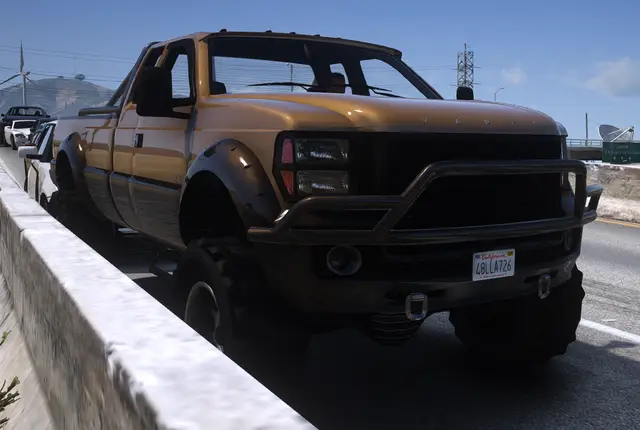 A pickup truck stopped on the shoulder of a road