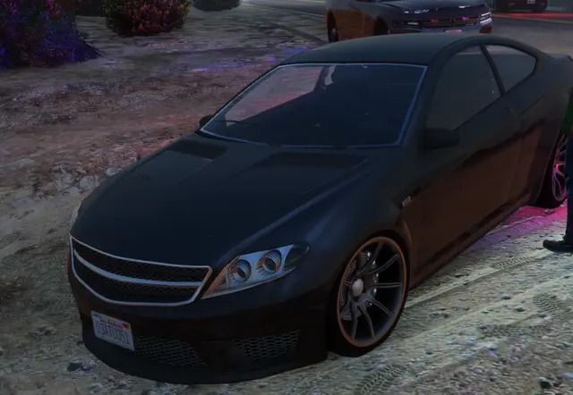 A sedan parked on a road at dusk