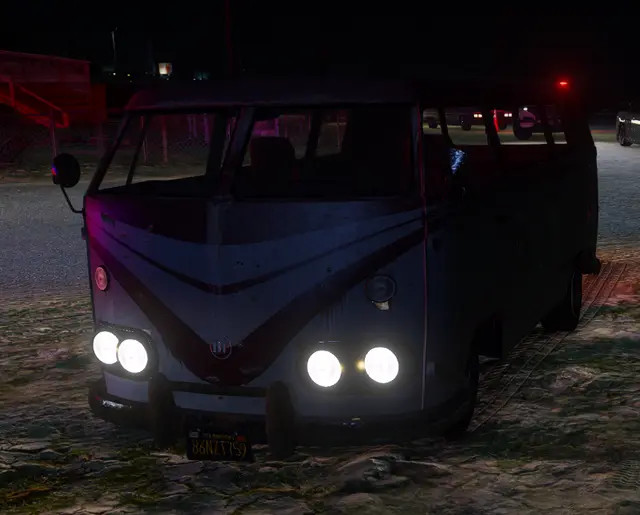 A van front-on with its headlights on at dusk