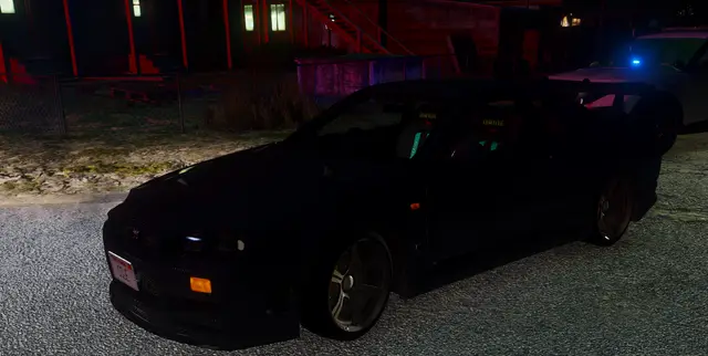 A dark car parked at night