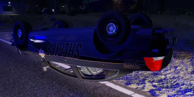 A car overturned on the road at night